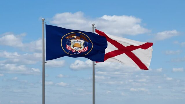 Alabama and Utah US state flags waving together on cloudy sky, endless seamless loop