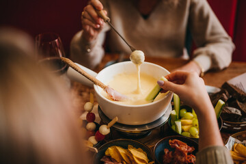 People eating cheesefondue in a restaurant