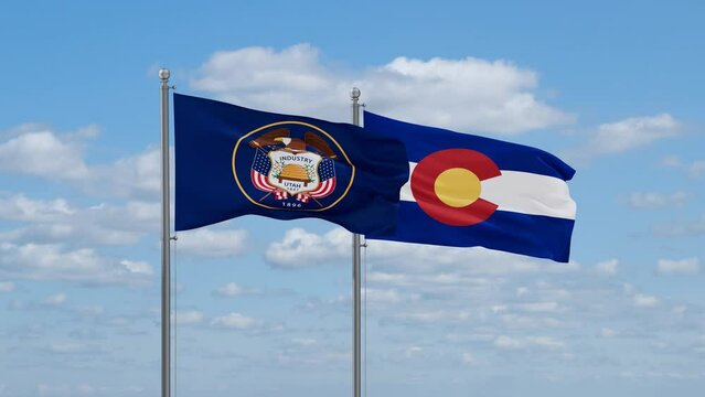 Colorado and Utah US state flags waving together on cloudy sky, endless seamless loop