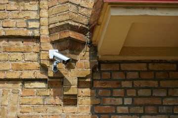 Video surveillance systems. Security systems and protection from theft. Security CCTV camera installed on the facade of a residential building. Digital technology.
