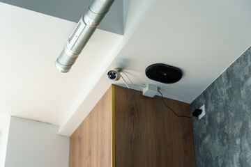 Modern surveillance cameras with remote Internet access inside the store. Beautiful office ceiling...