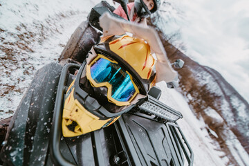  Close-up photograph, a quad rests on a snowy trail, showcasing the wintry adventure that awaits as...
