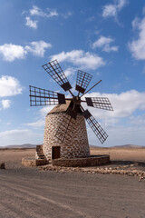 Ancient windmill Molino de Tefía with blue sky and some clouds in Fuerteventura, Spain