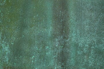Closeup of aged weathered copper plate texture with green patina.