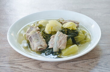 boiled pickled cabbage with pork bone in clear soup on plate
