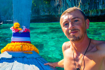 Tourist on Koh Phi Phi island Thailand with longtail boats.