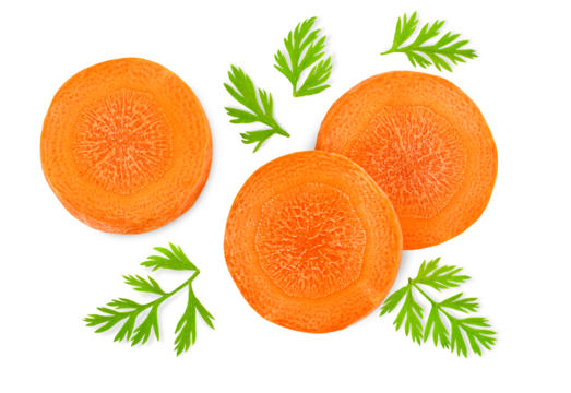 chopped carrot slices with leaves on a white isolated background, top view