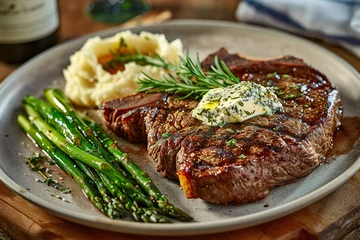  Grilled ribeye steak steak with asparagus and mashed potatoes on plate.  © Teeradej