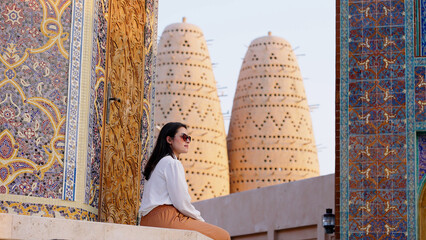 tourist woman sitted at Blue mosque of Katara village made of colorful mosaic in Doha Qatar showing...