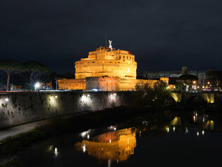 Castle of Sant Angel in Rome at the night. Reflection of it on Tiber river 