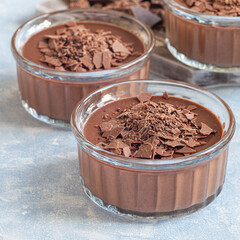Chocolate dessert Panna Cotta in glass ramekin, square