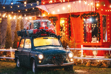 a green car with gifts on the roof on a background of light bulbs. a ready-made Christmas...