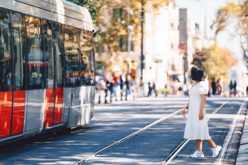 a girl's photo shoot in Istanbul. a girl in a white dress on the background of an Istanbul tram....