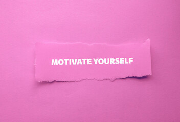 Motivate yourself lettering on ripped paper piece with pink background. Conceptual photo. Top view,...