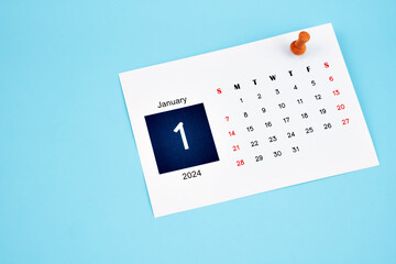 January 2024 calendar page with push pin on blue background.