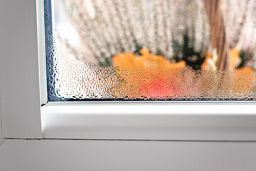 Selective focus on water condensation on window glass. Humidity in the house. Home moisture.	