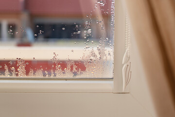 Selective focus on water condensation on window glass. Humidity in the house. Home moisture.	