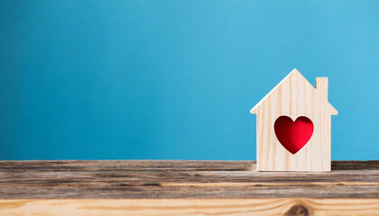 House wood with heart shape on wooden and blue background, copy space - Powered by Adobe
