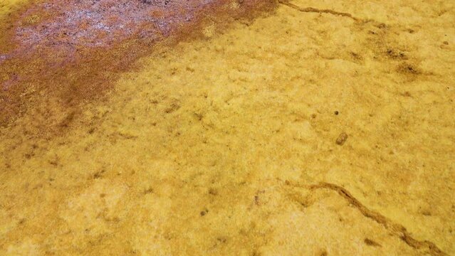 Sulfur stream after rare raine, dropped, supersaturated solutions, chemical fluvial sediments, Mountains of volcanic origin. Hormuz Island, Iran