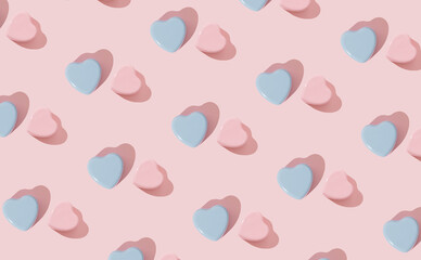 Trendy pattern made with smooth textured pastel blue and pink hearts on pastel peachy pink background. Minimal love concept. Creative romantic idea. Love aesthetic pattern background. Flat lay.