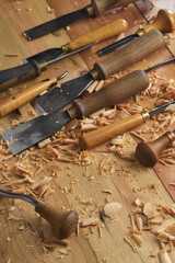 Professional tools on a wooden table in the workshop. Surface covered with sawdust. Carpenter working with tools close-up