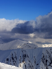 Snow mountains and blue sky with clouds - 700661012