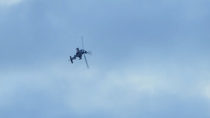 British army Boeing Apache Attack helicopter gunship AH64E (AH-64E ArmyAir606) at full bank in a hammerhead stall turn, Wiltshire UK