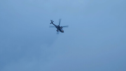 British army Boeing Apache Attack helicopter gunship AH64E (AH-64E ArmyAir606) at full bank in a hammerhead stall turn, Wiltshire UK