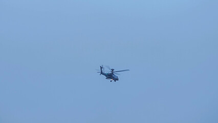British army Boeing Apache Attack helicopter gunship AH64E (AH-64E ArmyAir606) at full bank in a hammerhead stall turn, Wiltshire UK