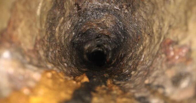 sliding inside old dirty and rusty cast iron sewer line pipe