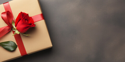 Gift box with red ribbon and roses on dark background. Top view with copy space happy valentine day