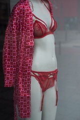 closeup of red underwear with little hearts on mannequin in a fashion store showroom 