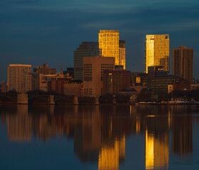 Panorama of Boston skyline and reflection in Charles River at sunset on a winter day
