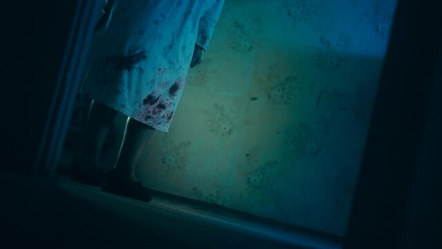 Spooky woman dragging sledgehammer in a dark haunted psychiatric ward, horror