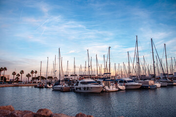 Sailboat harbor in the port evening photo. Beautiful moored sail yachts in the sea, modern water transport Barcelona