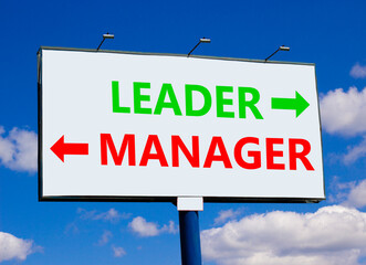 Leader or manager symbol. Concept word Leader or Manager on beautiful billboard with two arrows. Beautiful blue sky with clouds background. Business and leader or manager concept. Copy space.