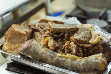 Slicing of beef and sausage kazy for Kazakh beshparmak. Preparation of horse meat by the chef for hot dishes. Cutting large pieces of kazi meat into small slices