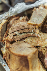 Slicing beef meat for Kazakh beshparmak. Preparation of horse meat by the chef for hot dishes. Cutting large pieces of meat into small slices