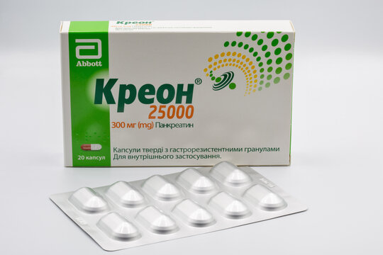 Creon pancreatin pack and blister closeup against white.