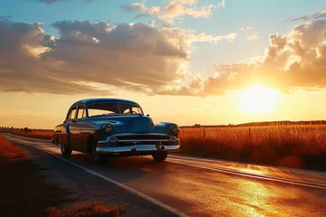 Foto auf Alu-Dibond A vintage car driving into the sunset. © Nicole
