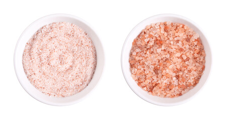 Himalaya pink salt, fine and coarse, in white bowls. Fine Himalayan salt, rock salt and halite with...