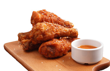 Crispy grilled chicken thighs and sauce on a wooden table