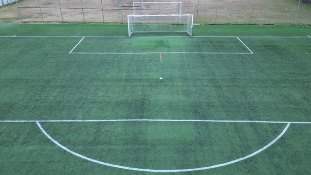Drone aerial view of empty soccer football field without players during Covid-19 Coronavirus outbreak lockdown - sport activities 