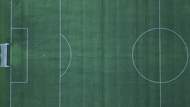 Drone aerial view of empty soccer football field without players during Covid-19 Coronavirus outbreak lockdown - sport activities 