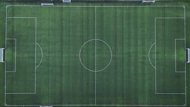 Drone aerial view of empty soccer football field without players during Covid-19 Coronavirus outbreak lockdown - sport activities  - Powered by Adobe