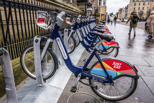 Edinburgh, Scotland - January 19, 2020: Just Eat shared system cycles in historic part of Edinburgh