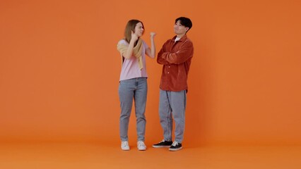 Angry European woman yells at positive Asian man in premise