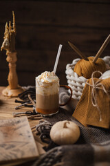 Pumpkin latte and decorative pumpkins nearby