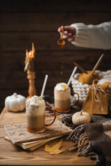 Pumpkin latte and decorative pumpkins nearby