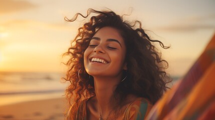 Gleeful Latin lady unwinding on shore with shut lids during dusk. Lovely multiracial lady savoring breeze tousling locks. Alluring youth inhaling crisp air at beach in summertime. - obrazy, fototapety, plakaty